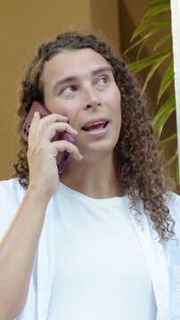 Person answering purple phone call, camera shifting up revealing white shirt, smiling for business