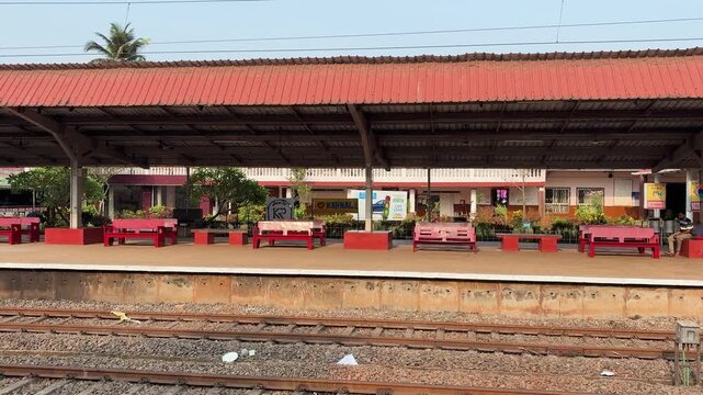 peaceful railway platform scene with benches and station structure at konkan railway