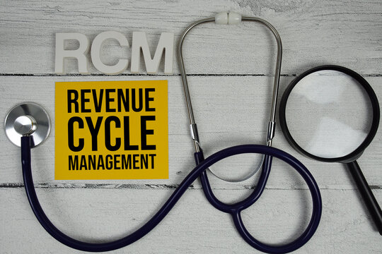 RCM Revenue Cycle Management text with Stethoscope on wooden background