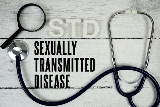 STD Sexually Transmitted Disease text with Stethoscope on wooden background