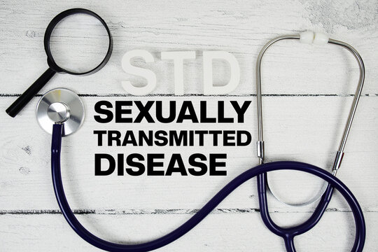 STD Sexually Transmitted Disease text with Stethoscope on wooden background