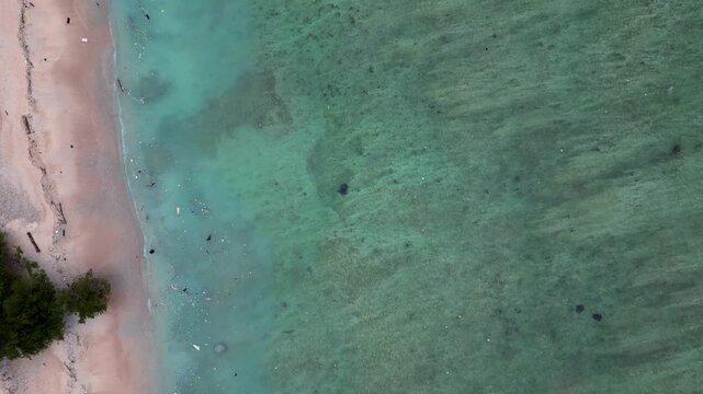 Sea turtle swimming in plastic polluted ocean water. Lovely aerial view drone