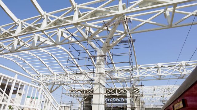 steel truss roof structure under construction with scaffolding