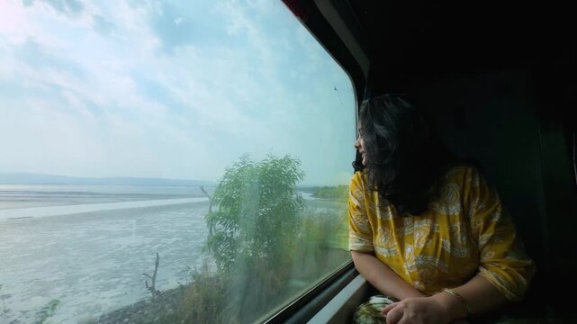 travel moment with woman gazing konkan railway landscape through train window
