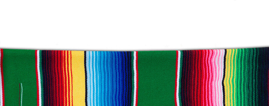 Colorful serape on wooden table. Typical colorful fabric from Mexico. Cinco de Mayo background.