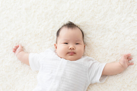 Cute Chinese baby on Bed 
