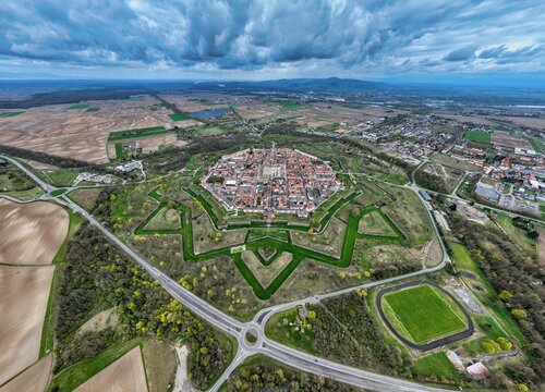 Aerial view of the star-shaped fortress city, a testament to military architecture, with its symmetrical bastions, moats, and red-roofed buildings, Neuf-Brisach, Grand Est, France.