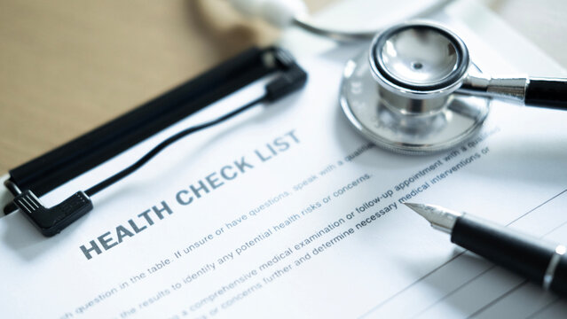 Close up of health check list with stethoscope and pen on medical form, healthcare screening, diagnosis and patient consultation concept.