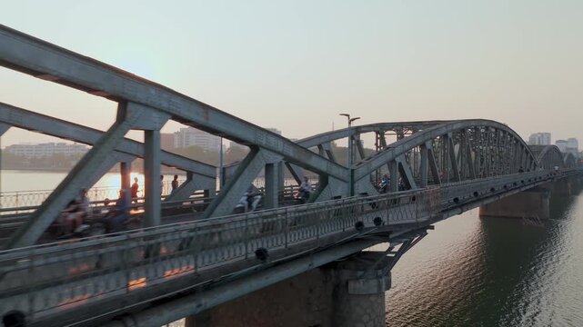 Aerial view of Truong Tien Bridge at sunrise over Perfume River with traffic in Hue City