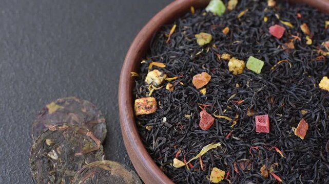 Dry black tea with herbal leaves and aromatic additives. Dry fruity black tea as a background for your design