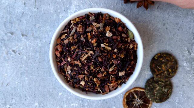 Dry herbal or fruit tea with flower petals and aromatic additives. Dry fruit herbal tea as a background for your design