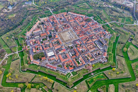 Aerial view of the star-shaped fortress city with its symmetrical layout and red-roofed buildings, blending history and nature, Neuf-Brisach, Grand Est, France.