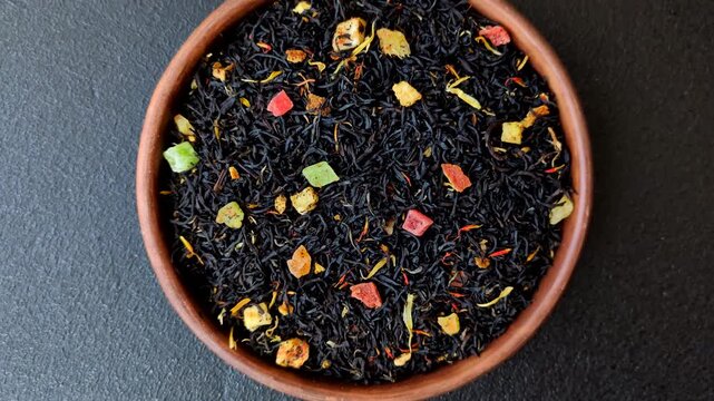 Dry black tea with herbal leaves and aromatic additives. Dry fruity black tea as a background for your design
