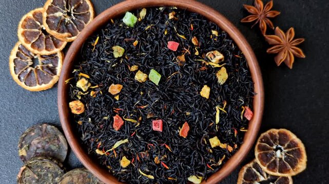 Dry black tea with herbal leaves and aromatic additives. Dry fruity black tea as a background for your design