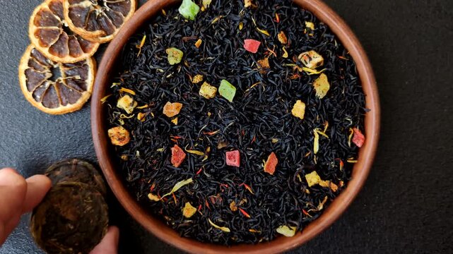 Dry black tea with herbal leaves and aromatic additives. Dry fruity black tea as a background for your design