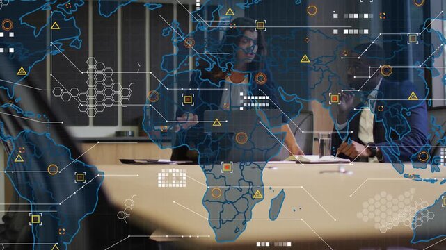 Woman pointing at laptop, animating world-map data for business strategy while man reviewing papers