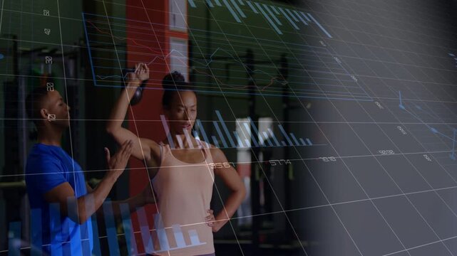 Vertical video: PT guiding elbow as woman raising arm overhead while fitness AR graphs scoring ROM