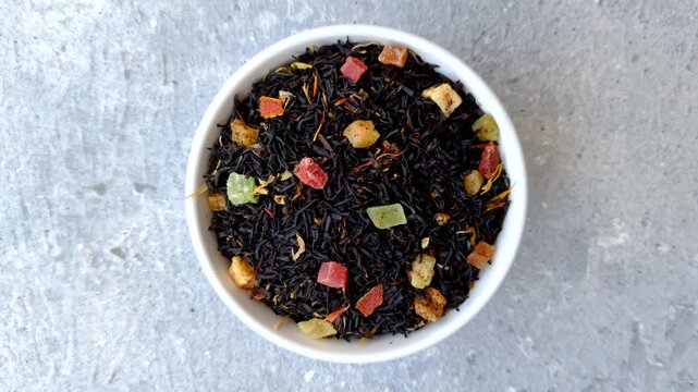 Dry black tea with herbal leaves and aromatic additives. Dry fruity black tea as a background for your design