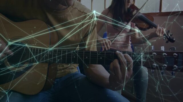 Guitarist playing while camera zooming out to reveal violinist rehearsing music, overlay on strings