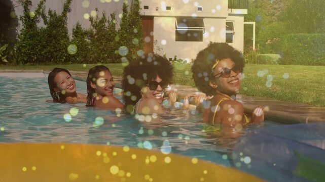 Vertical video: Leisure four women socializing holding edge turning while sun causing sparkly bokeh