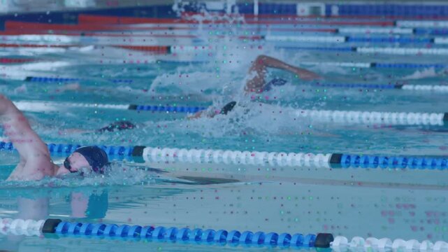 Vertical video: Center swimmer breathing and causing splashes as lanes holding steady swimming pace