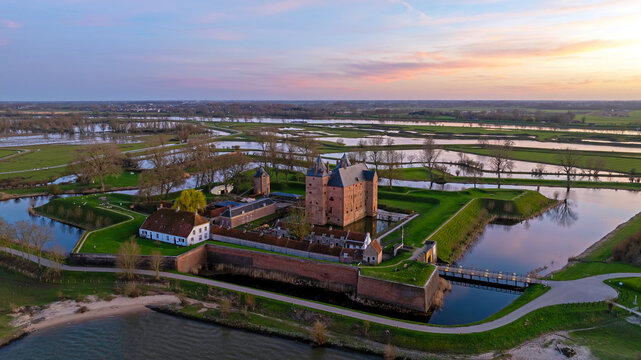 Medieval castle at sunset near a river landscape in Europe