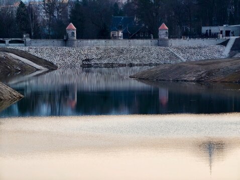 City water mirror. Quiet urban water scene. Serene urban water body mirroring structures and subdued sky