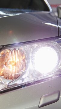 Close-up view of modern car headlight flashing