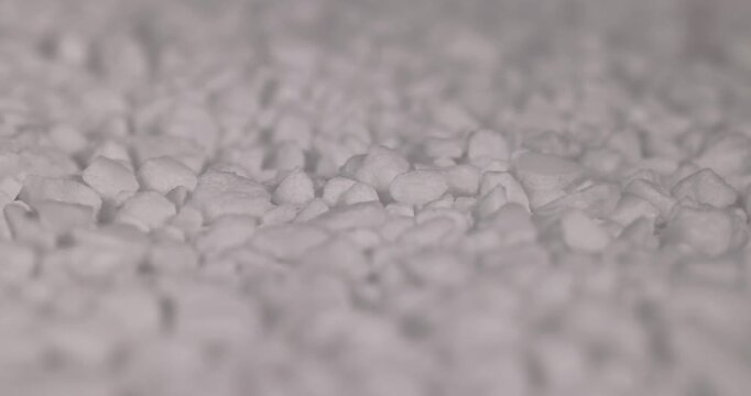 white coarse solid salt that is used in dishwashers to improve and soften water, white coarse crystals of special salt for dishwashers for good and long-lasting dishwasher operation