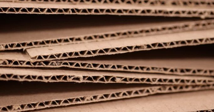Corrugated cardboard is stacked in rows, multi-layered corrugated cardboard with porous edges and a fleecy surface under soft light with an authentic look and high detail of packaging.