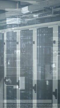 Vertical video: Camera panning right over rack row, HUD overlays pulsing on glass for monitoring