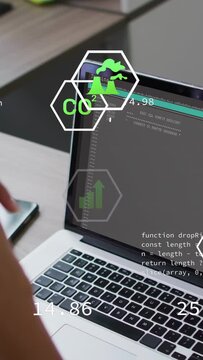Vertical video: Left hand tapping phone starting overlay visualizing CO2 and bars icons over laptop