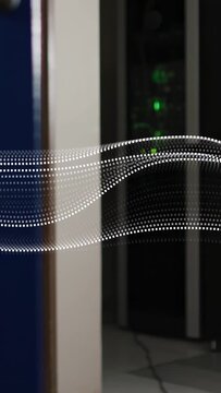 Vertical video: Dotted wave entering left moving right past rack showing green LEDs for network ops
