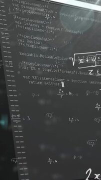 On play camera panning upward, computer display revealing code beneath faint math layers for review
