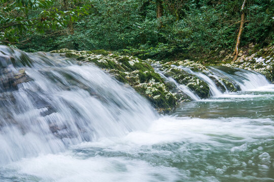 Waterfall in deep forest. Long exposure photo with motion blur.