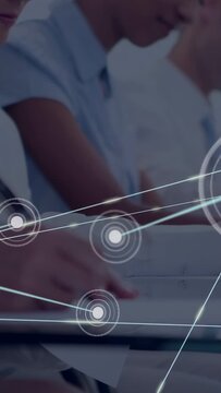 Vertical video: Hand writing in class, node appearing and expanding network over hand for training