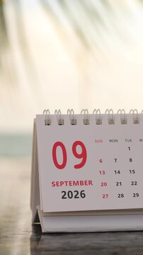 Slow motion footage of flip calendar pages for change months from september to october of the year 2026. concept of planning and starting a new month. 4k vertical.