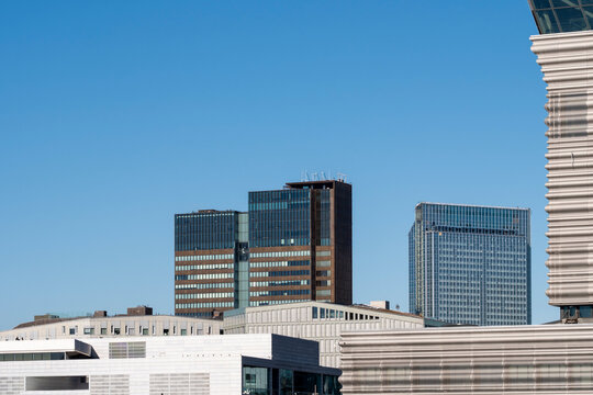 Minimal modern architecture building facade skyline cityscape of distant office towers and reflective glass under wide sky clouds background with metropolitan atmosphere