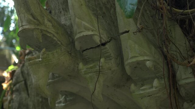 Close up shot of a four headed Naga limestone carving at the Dragon Cave complex in Laos