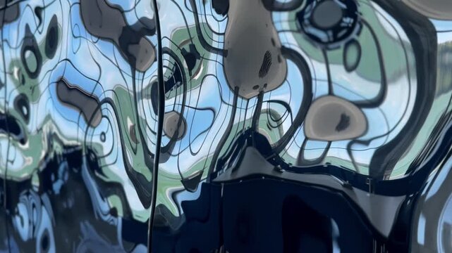 Abstract slow motion of liquid metal water ripple texture. Futuristic chrome wavy reflection on steel surface. Cinematic fluid metallic background for technology, luxury, and digital design. 