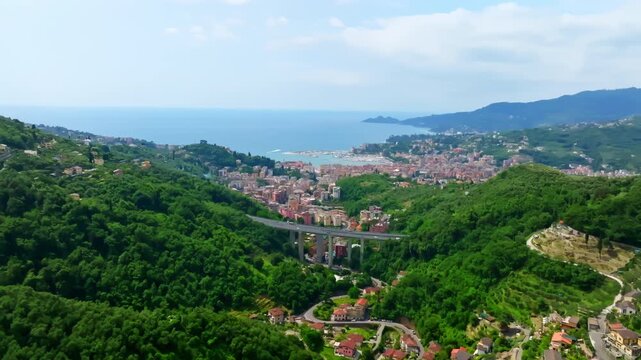 Establishing drone shot of Rapallo city, daytime at the Gulf of Tigullio, Italy