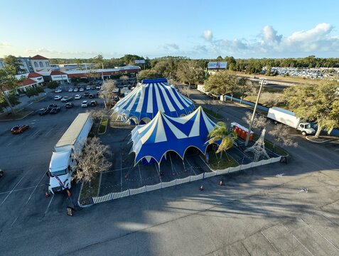 Aerial view of the blue and white striped circus tents standing tall against the backdrop of the surrounding urban landscape, St. Augustine, Florida, United States.