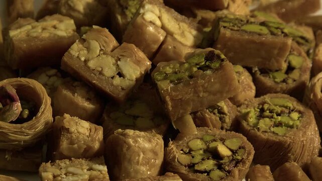 Full frame closeup: Delicious baklava pastry stacked on rotating plate