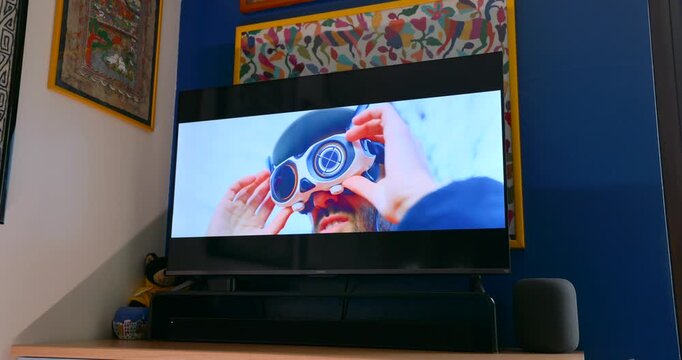 Xiaomi smart TV displaying person recording a vlog with mountains in the background