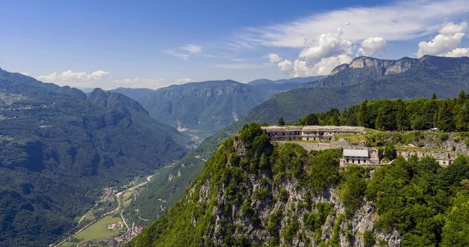 Forte Corbin, an Italian WWI landmark, sits on a mountain cliff surrounded by lush forests. Aerial Hyperlapse
