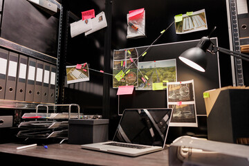 Empty dark police detective room with murder case investigation process on board. Suspect...
