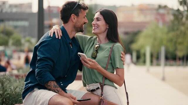Video of attractive man using his phone while waiting for his partner in the park
