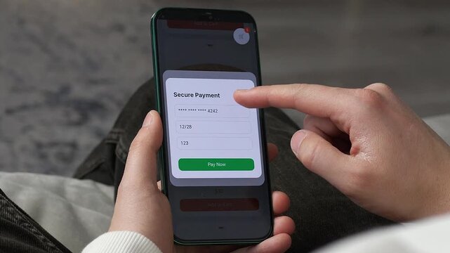 Close-up of a person making a secure payment on a smartphone. Finger taps the Pay Now button to complete a purchase. Perfect for e-commerce, mobile shopping apps, and modern consumerism visuals. High
