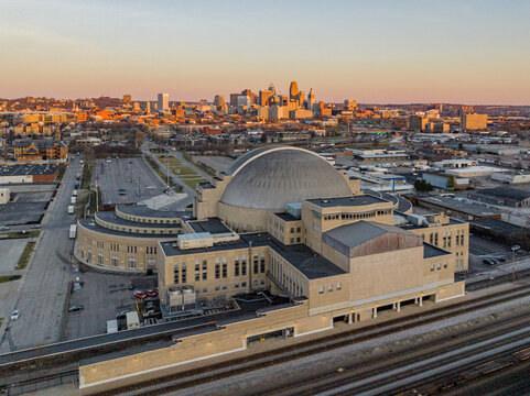 Aerial view of the beige Music Hall and the Union Terminal station standing majestically against the skyline's warm sunset hues, Cincinnati, Ohio, United States.