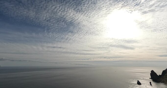 Clouds Ocean Timelapse dramatic mackerel sky formation over dark still sea stacks